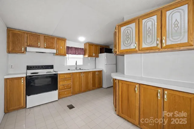 a kitchen with stainless steel appliances granite countertop a stove and a refrigerator
