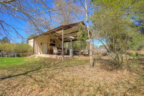 a view of a grassy field with an trees