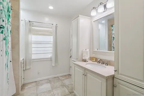 a bathroom with a sink vanity and a mirror