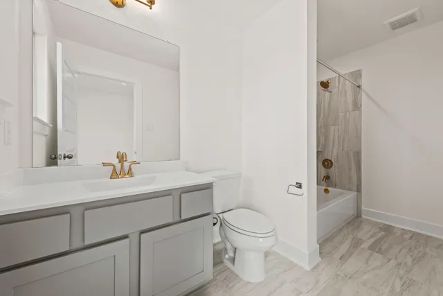 a front view of a house with a yard and a garage