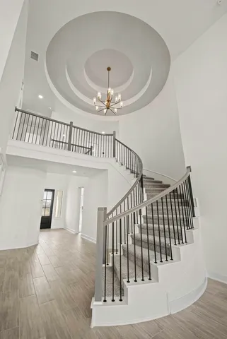 a view of a hallway with chandelier