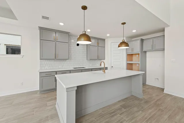 an empty room with windows and ceiling fan