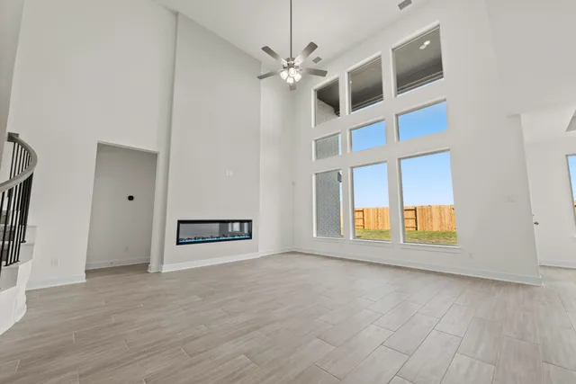 a view of a livingroom with a ceiling fan and window