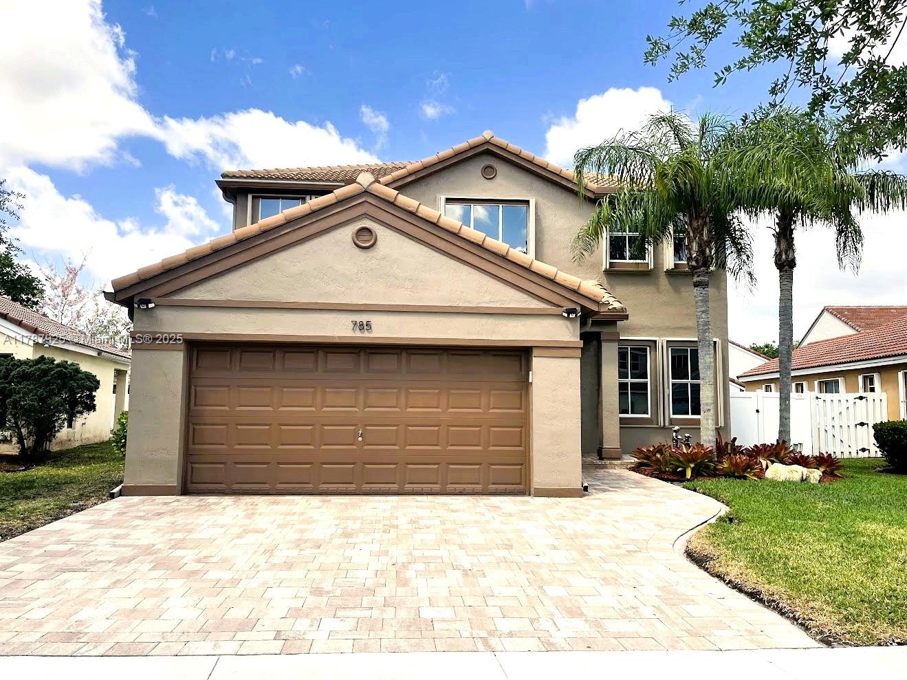 785 Falling Water Road Weston, FL 33326 - Photo 1 of 45 a front view of a house with a yard and garage