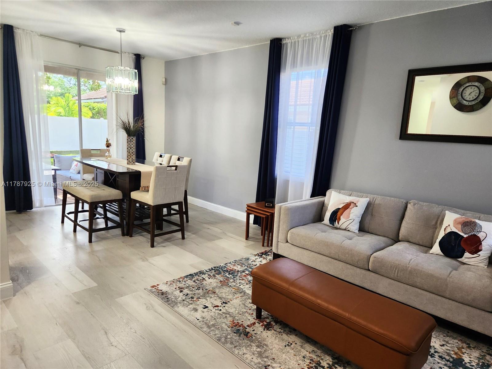 785 Falling Water Road Weston, FL 33326 - Photo 13 of 45 a living room with furniture and a large window