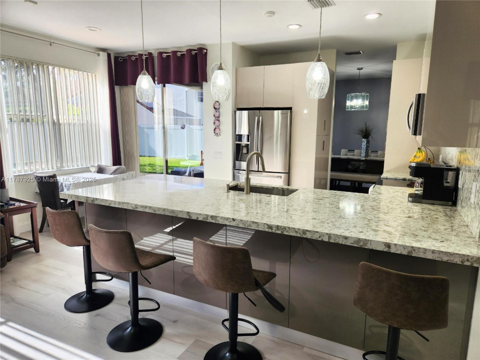 785 Falling Water Road Weston, FL 33326 - Photo 16 of 45 a kitchen with a counter space a sink appliances and a window