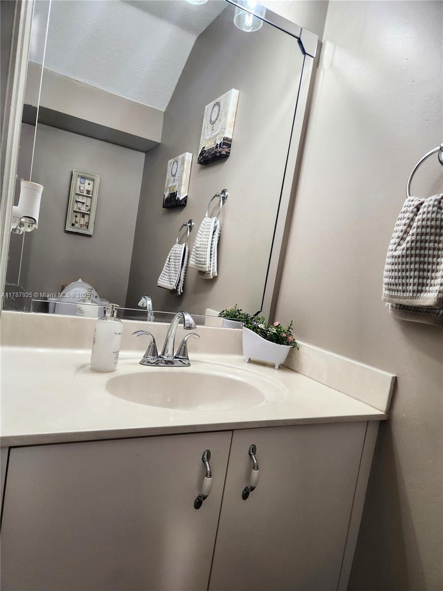 785 Falling Water Road Weston, FL 33326 - Photo 21 of 45 a bathroom with a sink and a mirror