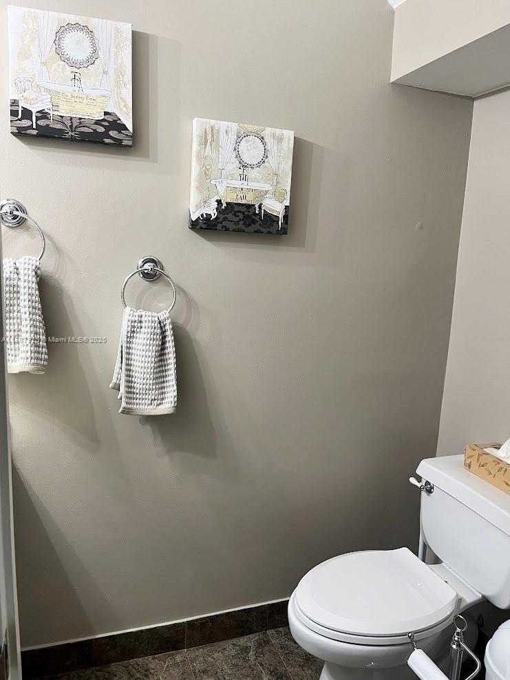 785 Falling Water Road Weston, FL 33326 - Photo 22 of 45 a white toilet sitting next to a sink