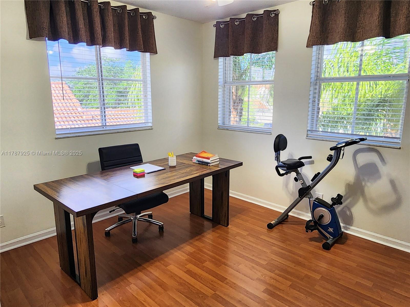 785 Falling Water Road Weston, FL 33326 - Photo 26 of 45 a view of a workspace with furniture and a window