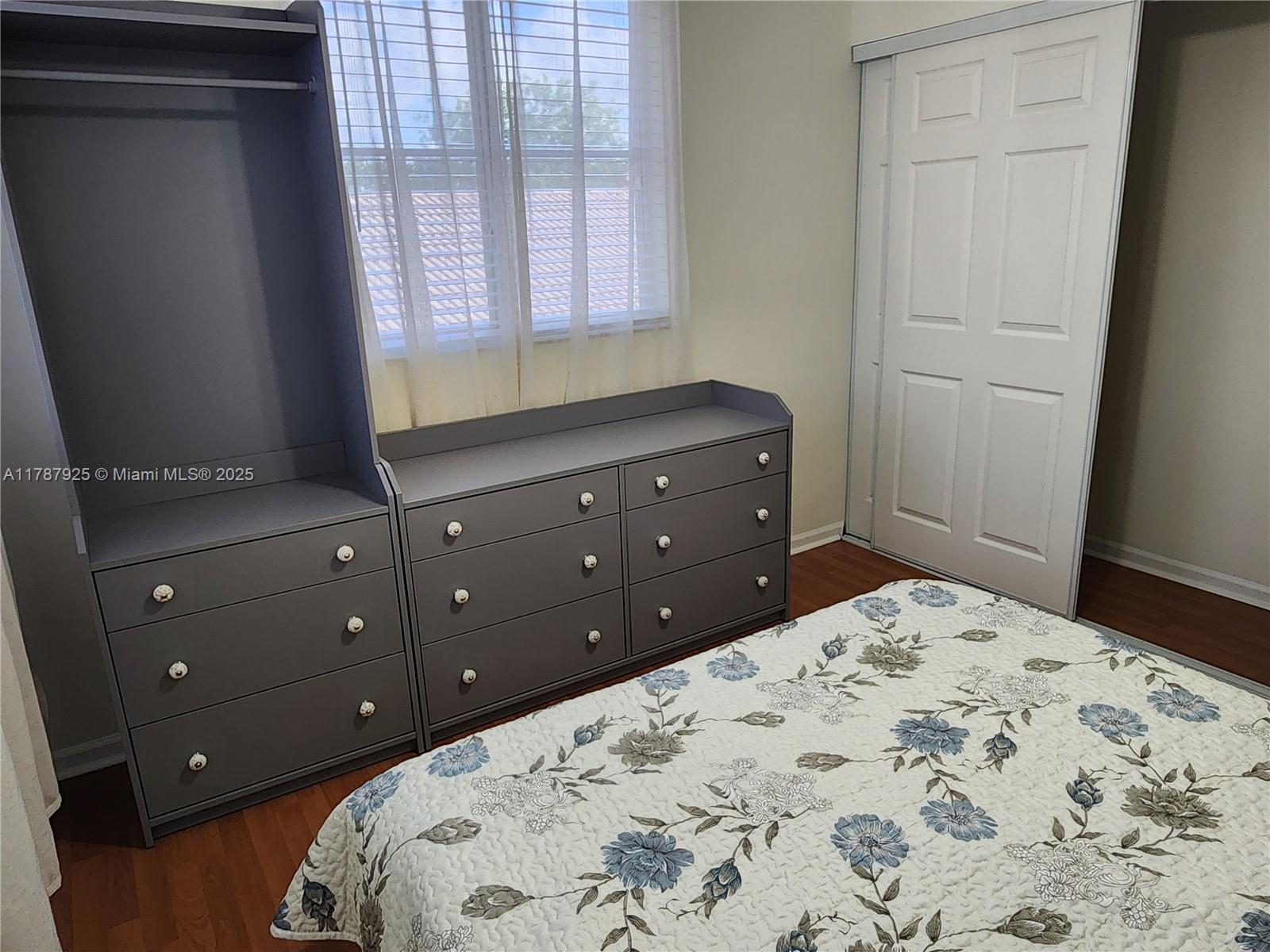 785 Falling Water Road Weston, FL 33326 - Photo 29 of 45 a bedroom with a bed and a dresser
