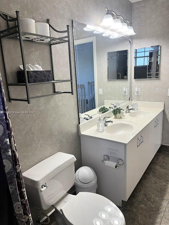 785 Falling Water Road Weston, FL 33326 - Photo 30 of 45 a bathroom with a sink mirror vanity and toilet