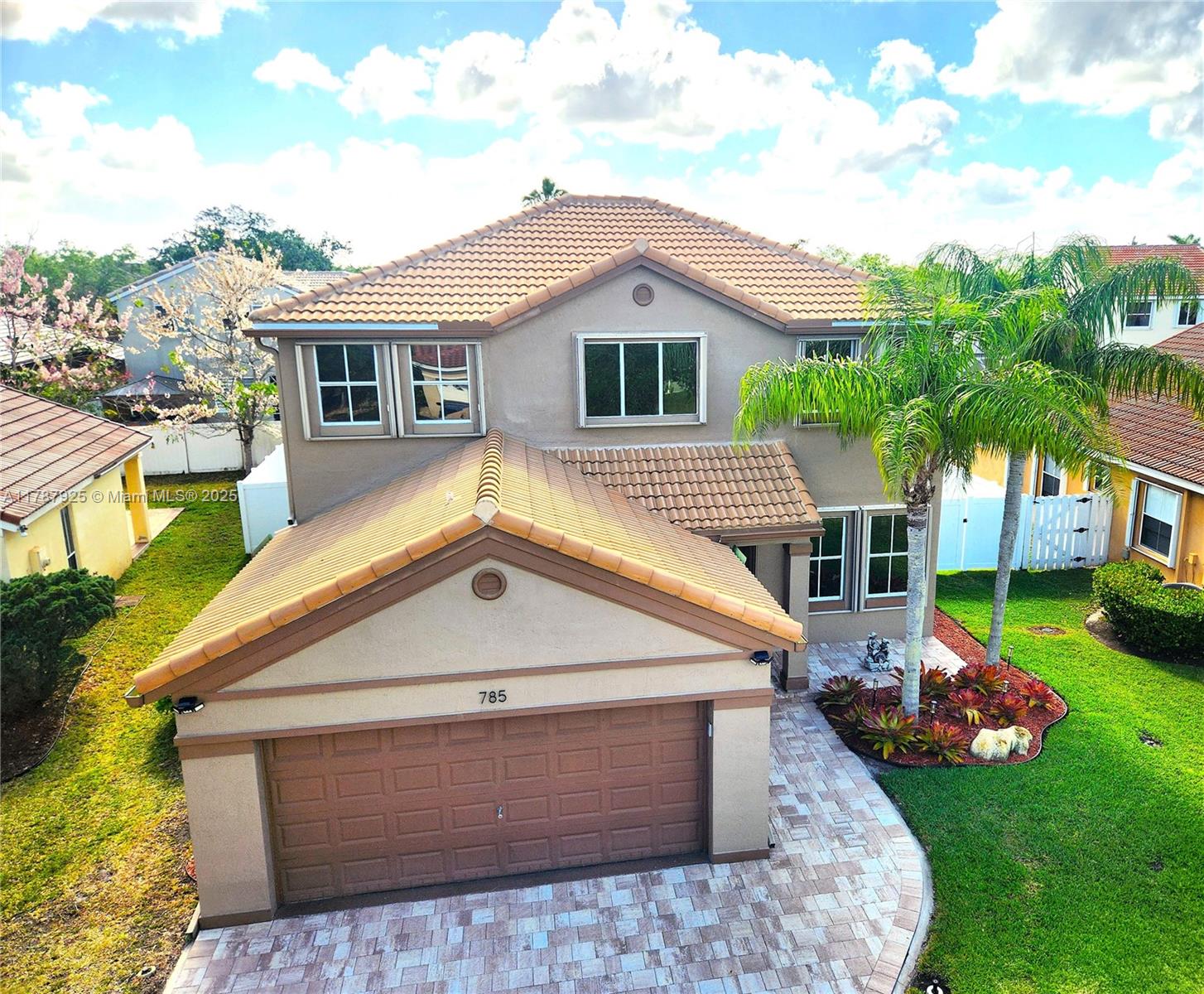 785 Falling Water Road Weston, FL 33326 - Photo 3 of 45 a front view of a house with garden