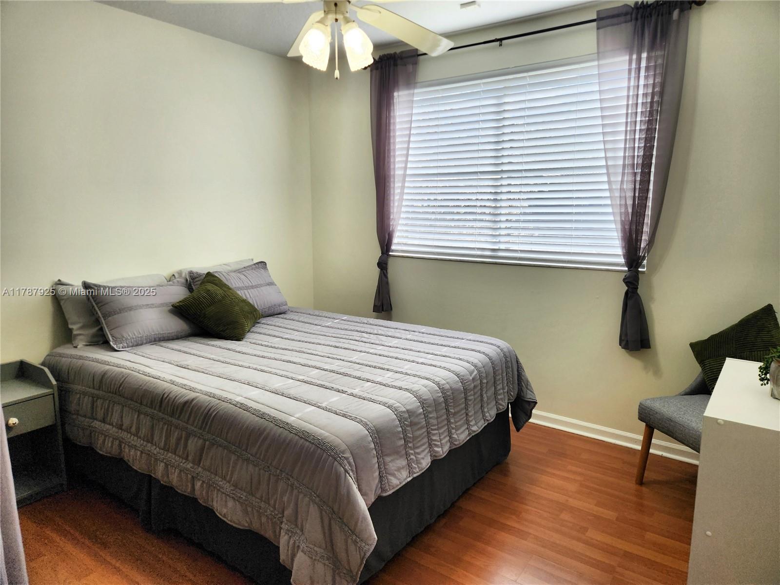785 Falling Water Road Weston, FL 33326 - Photo 31 of 45 a bedroom with bed and window