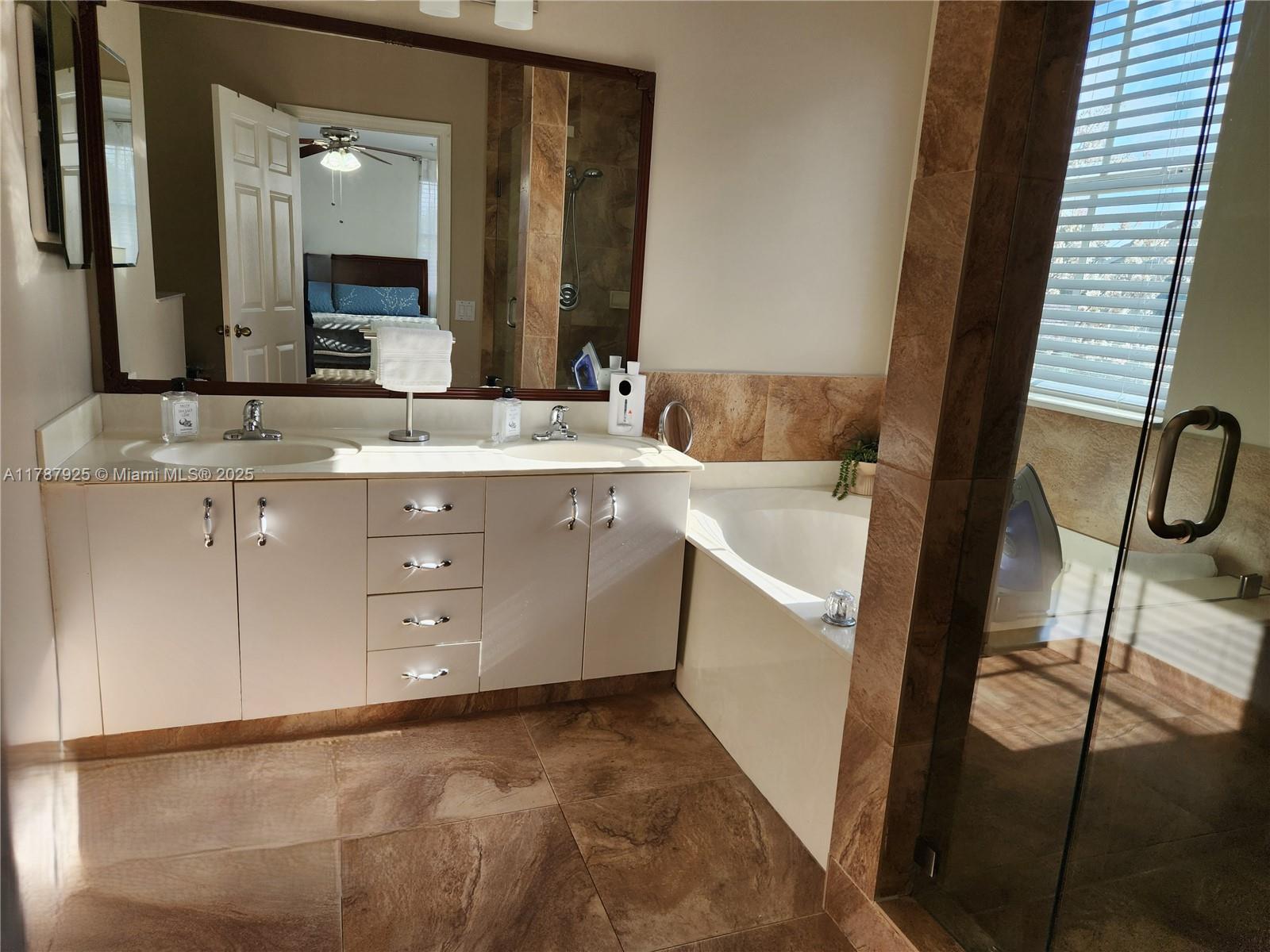 785 Falling Water Road Weston, FL 33326 - Photo 34 of 45 a bathroom with a sink and a mirror