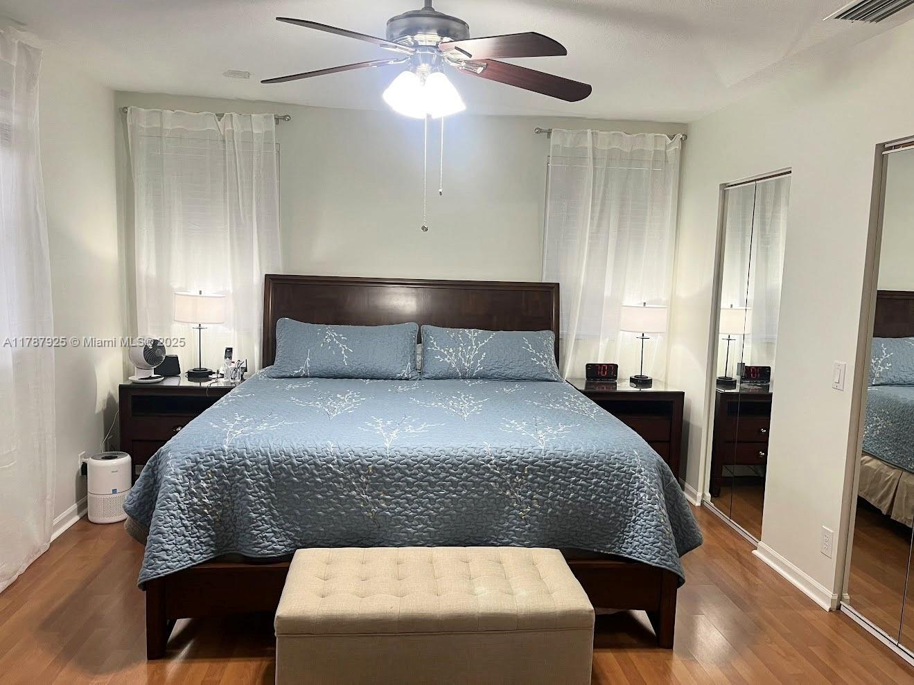 785 Falling Water Road Weston, FL 33326 - Photo 38 of 45 a bedroom with a bed and a chandelier