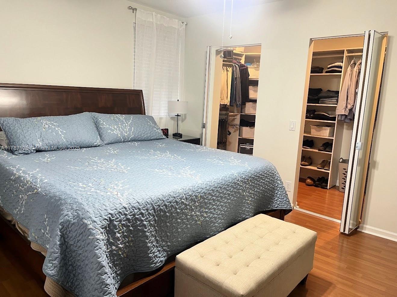 785 Falling Water Road Weston, FL 33326 - Photo 39 of 45 a bedroom with a bed and wooden floor