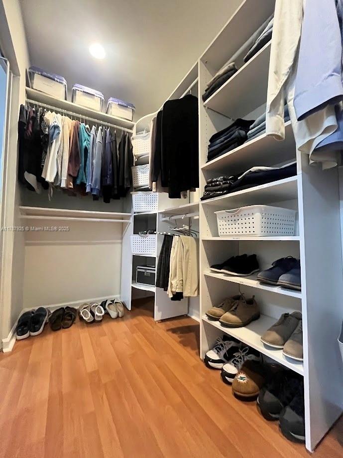 785 Falling Water Road Weston, FL 33326 - Photo 41 of 45 a view of walk in closet with clothes and shoes