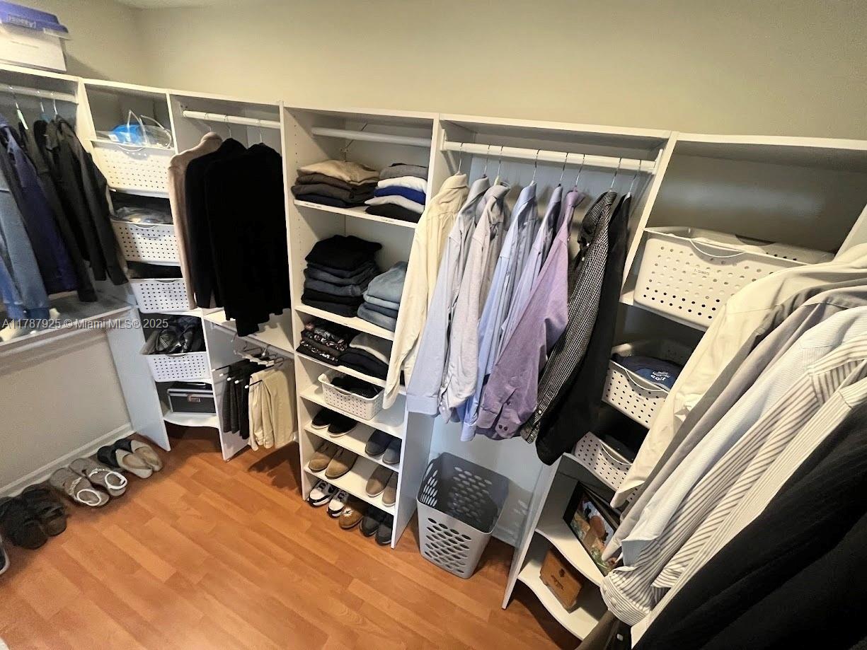 785 Falling Water Road Weston, FL 33326 - Photo 43 of 45 a view of walk in closet with clothes and shoes