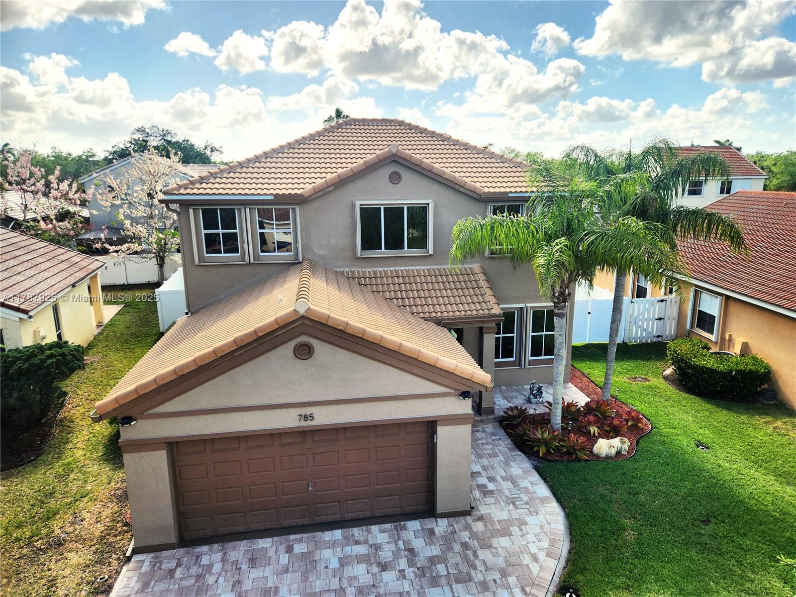 785 Falling Water Road Weston, FL 33326 - Photo 44 of 45 a front view of a house with garden