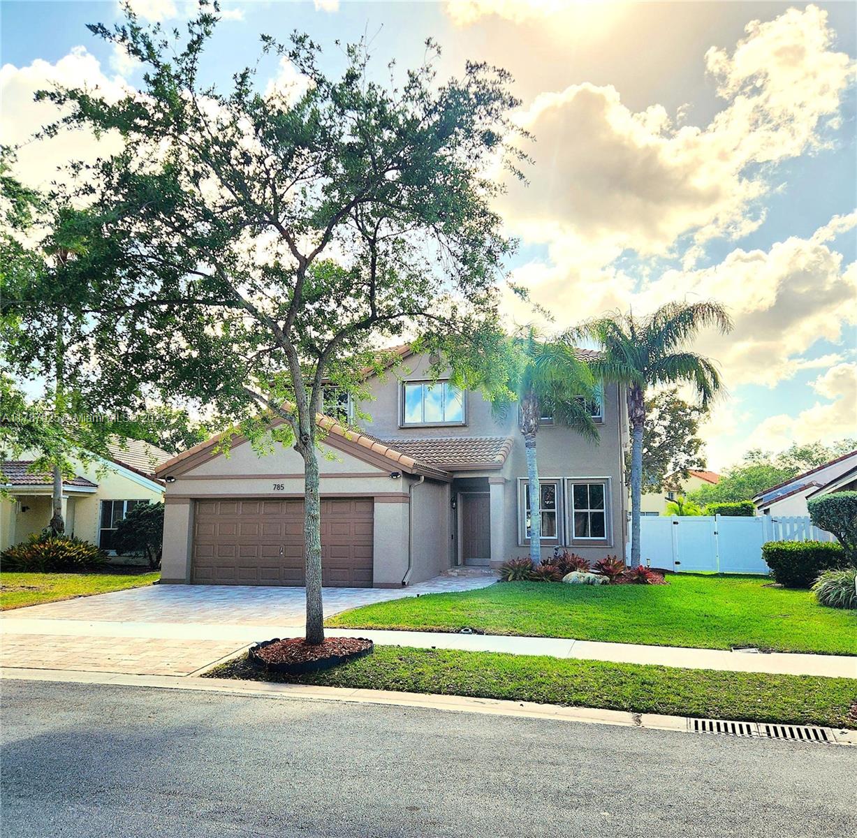 785 Falling Water Road Weston, FL 33326 - Photo 45 of 45 a front view of a house with a garden and trees