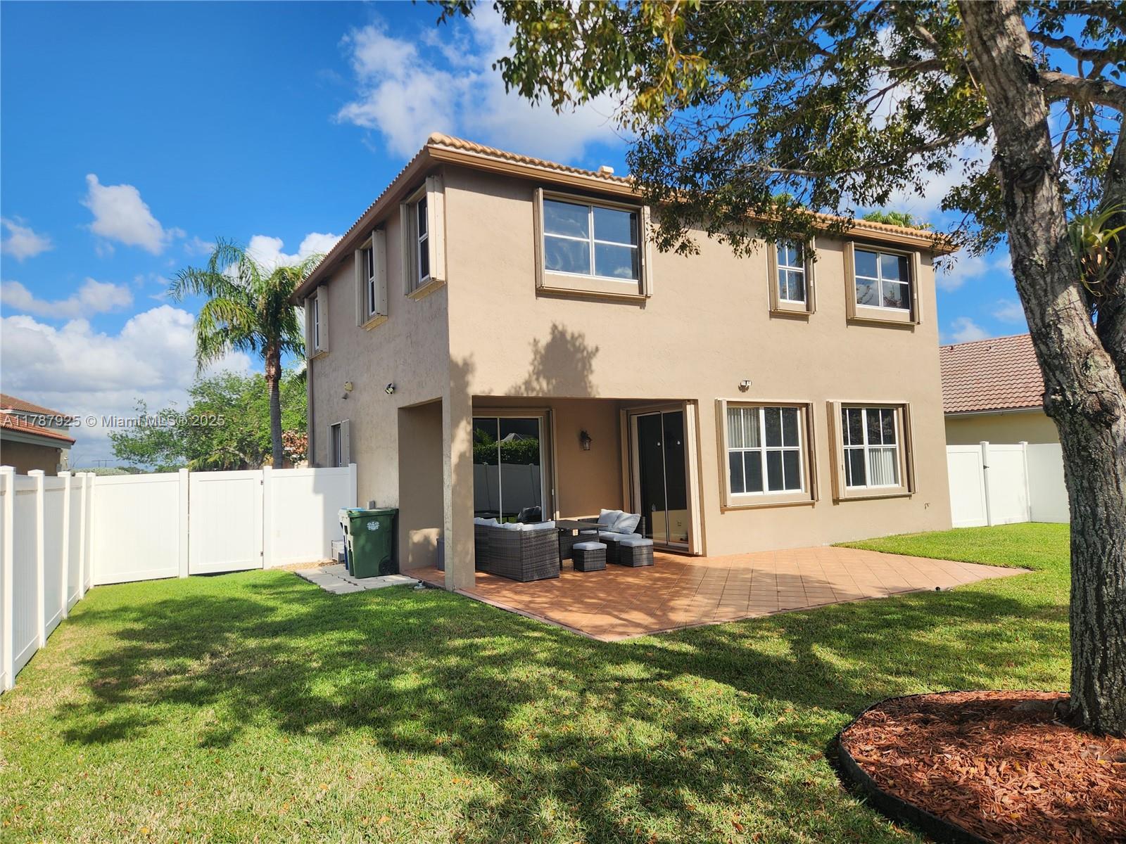 785 Falling Water Road Weston, FL 33326 - Photo 7 of 45 a front view of a house with a yard