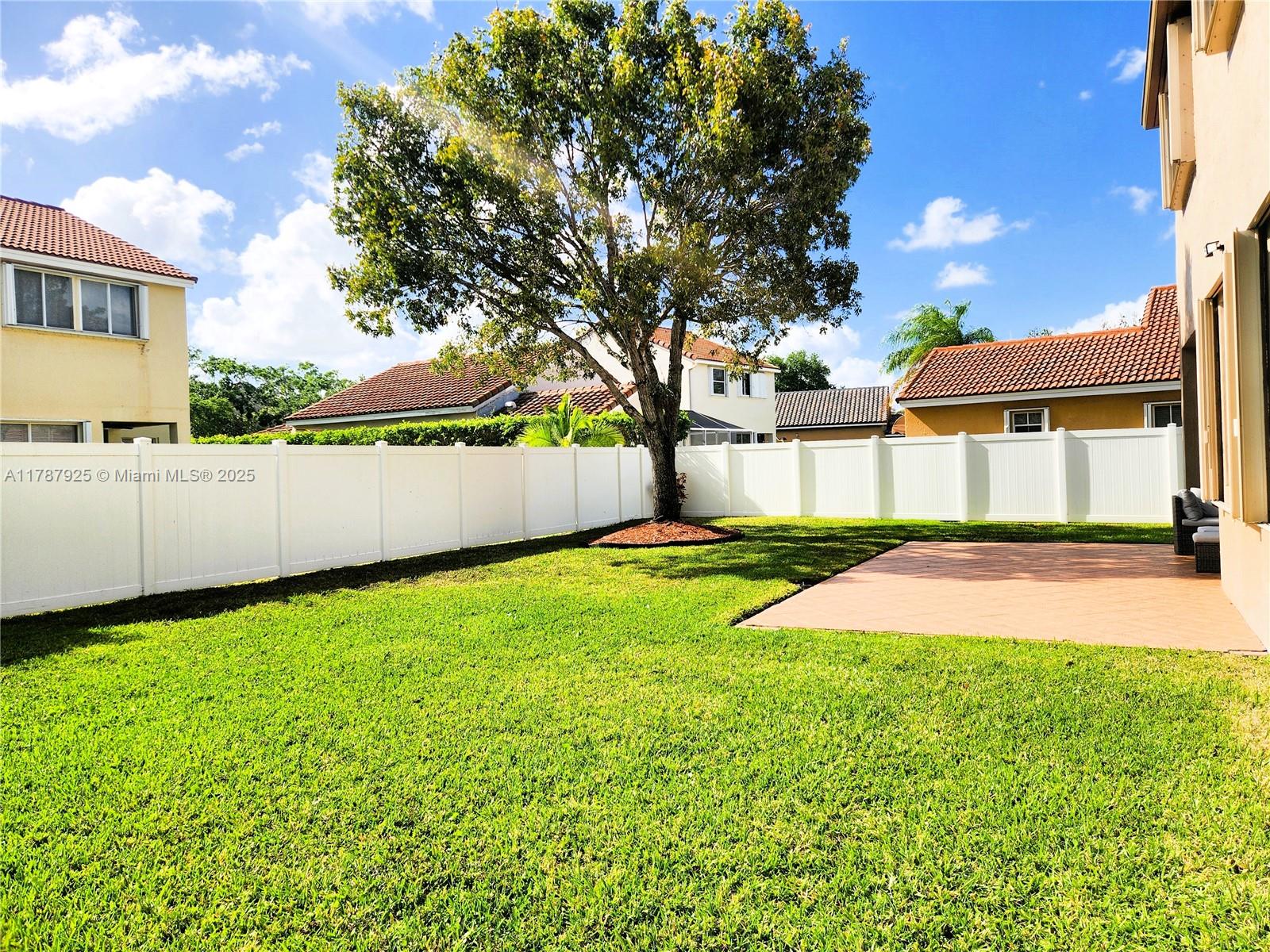 785 Falling Water Road Weston, FL 33326 - Photo 9 of 45 a view of an house with backyard and tree
