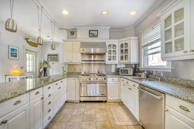 a kitchen with a stove sink and refrigerator