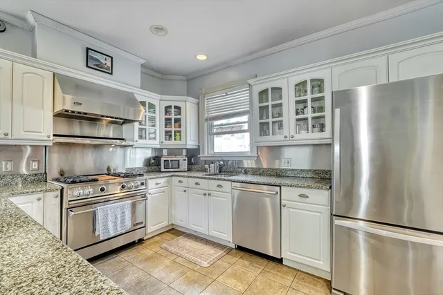a kitchen with stainless steel appliances granite countertop a sink and a granite counter tops