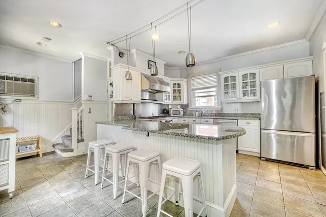 a very nice looking kitchen with a large window and stainless steel appliances