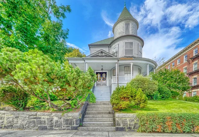 a front view of a house with a garden