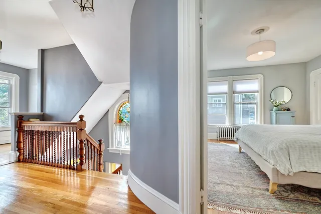 a bedroom with a bed and a large window