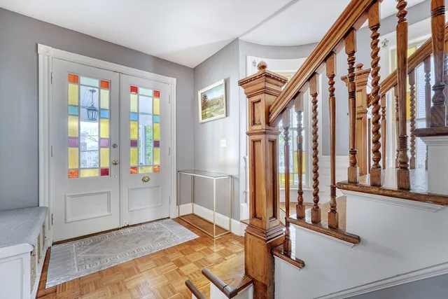 a view of entryway and hall with wooden floor