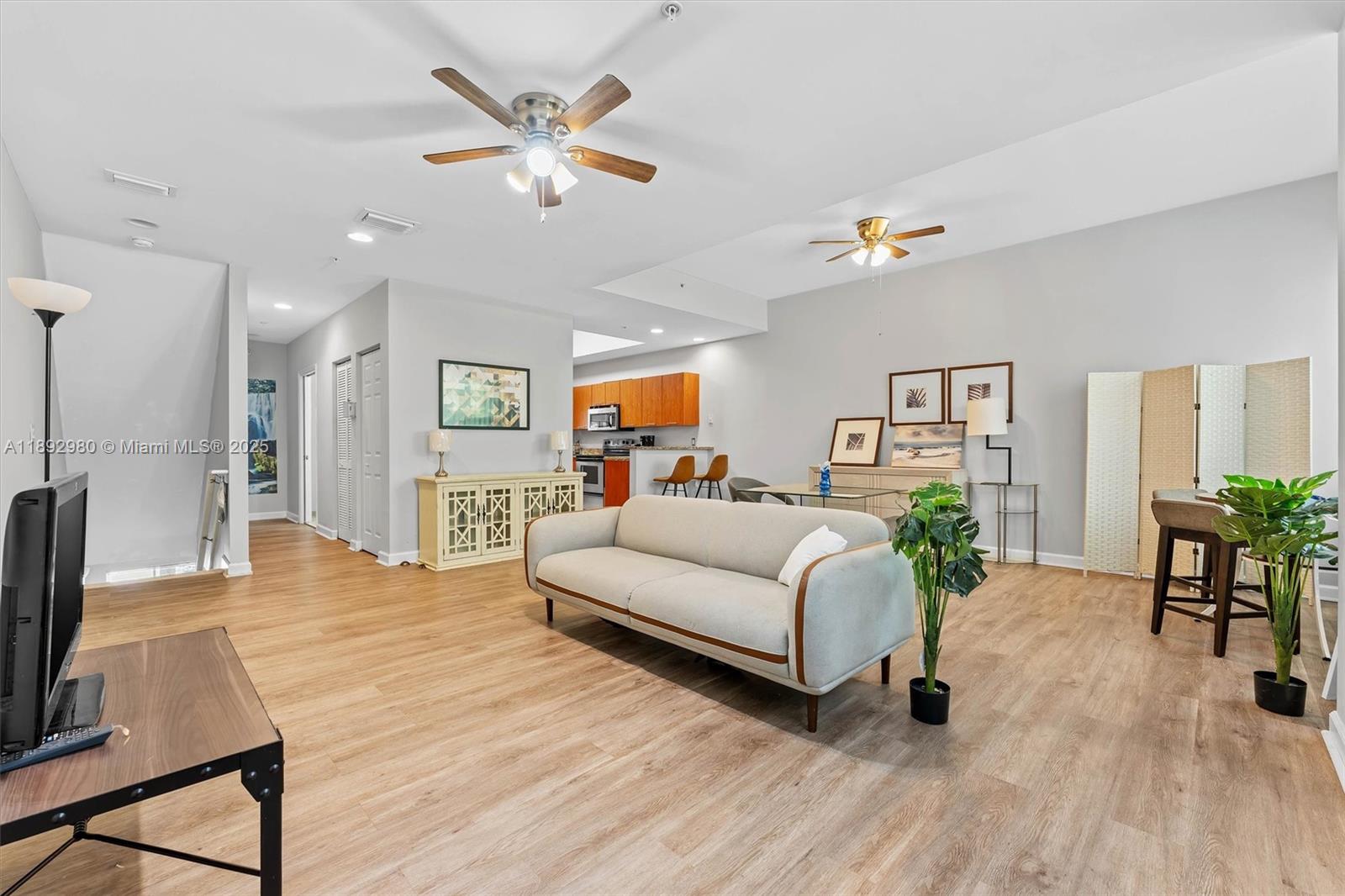 a living room with furniture and a wooden floor