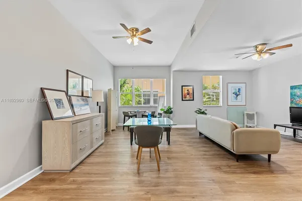 a living room with furniture and a wooden floor