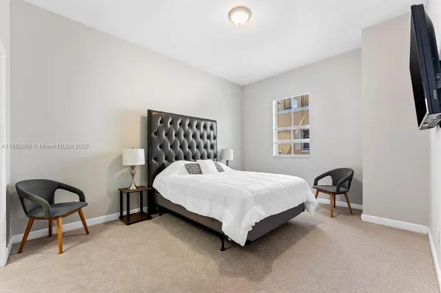 a bedroom with a bed and a chair in it