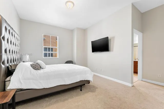 a bedroom with a bed and flat screen tv