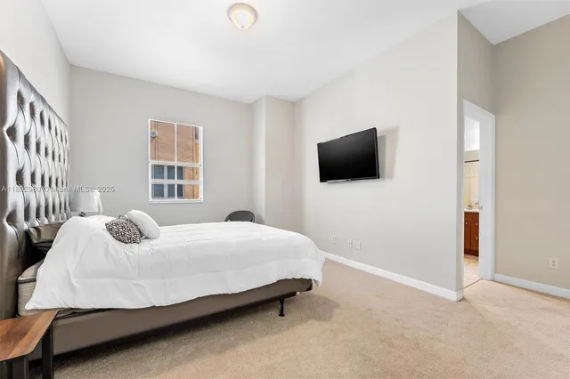 a bedroom with a bed and flat screen tv