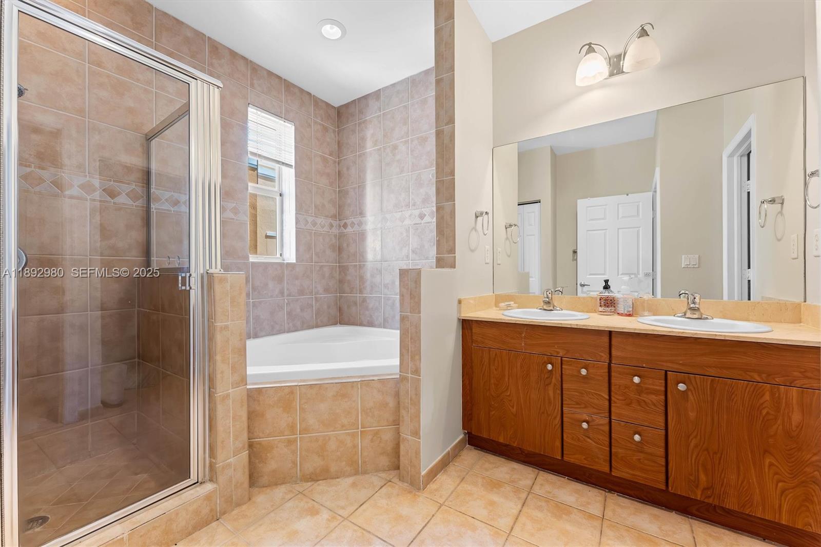 2344 Vintage Drive Lighthouse Point, FL 33064 - Photo 9 of 26 a spacious bathroom with a tub sink shower and mirror