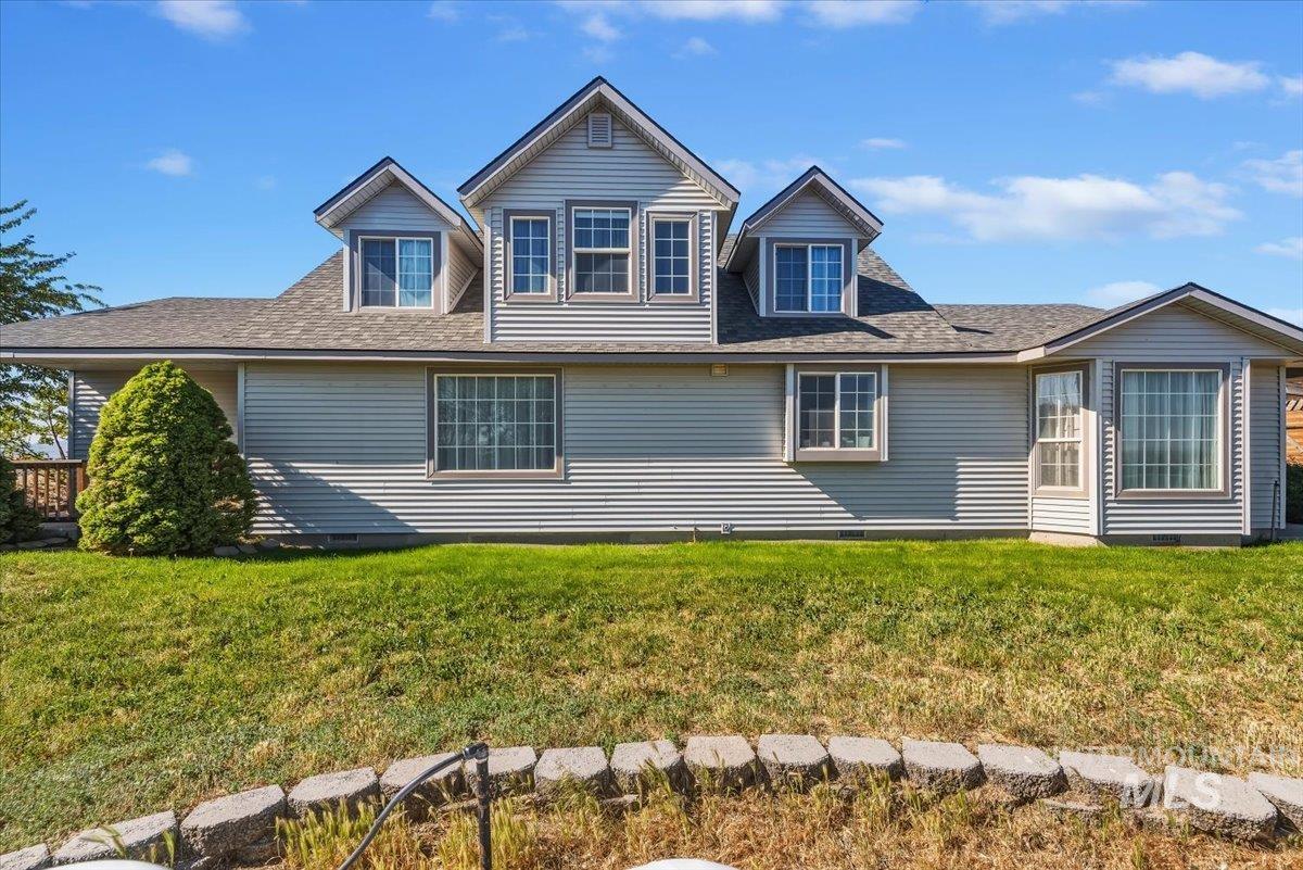 2331 Gulley Road Homedale, ID 83628 - Photo 2 of 46 Light-toned horizontal siding exterior featuring multiple dormer windows, a bay window, and a covered porch with a wood railing