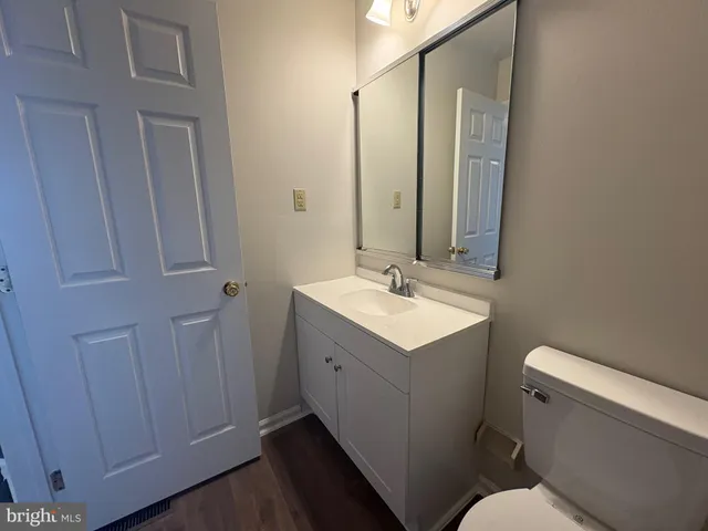 a bathroom with a sink mirror vanity and toilet