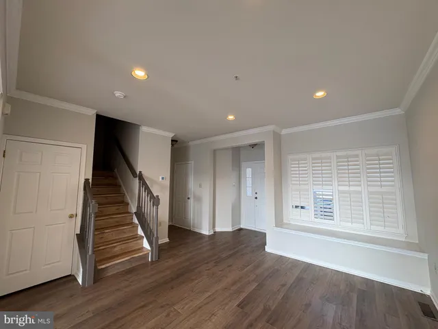 a view of entryway with wooden floor and stairs