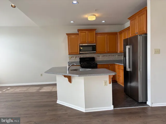 a kitchen with a refrigerator stove and cabinets