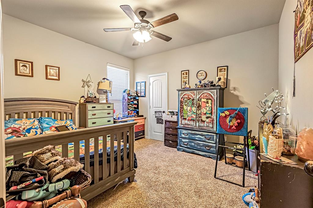 3206 Meadow Ridge Drive Midlothian, TX 76065 - Photo 12 of 37 a view of a bedroom with furniture fan and window