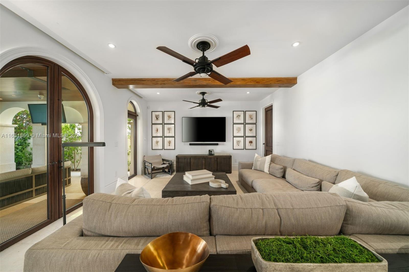 7825 Atlantic Way Miami Beach, FL 33141 - Photo 15 of 33 a living room with furniture a flat screen tv and a large window