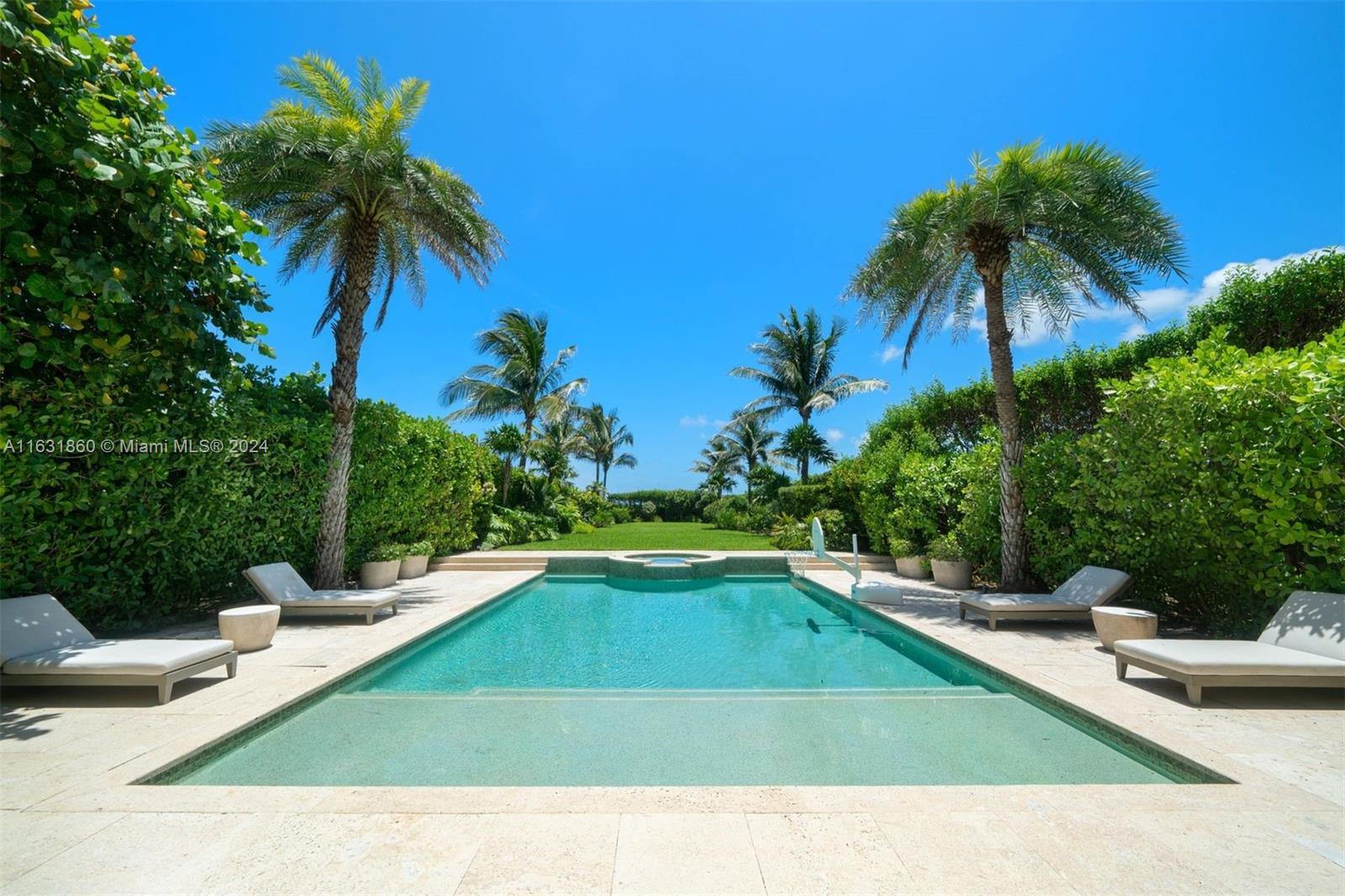 7825 Atlantic Way Miami Beach, FL 33141 - Photo 18 of 33 a view of a swimming pool with a garden