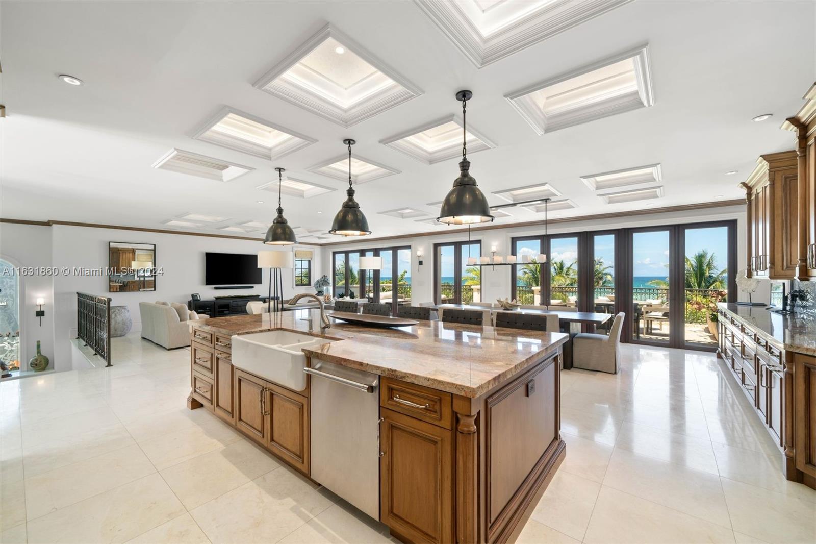 7825 Atlantic Way Miami Beach, FL 33141 - Photo 28 of 33 a view of a open kitchen with a stove top oven a barbeque with a dining table and chairs with wooden floor
