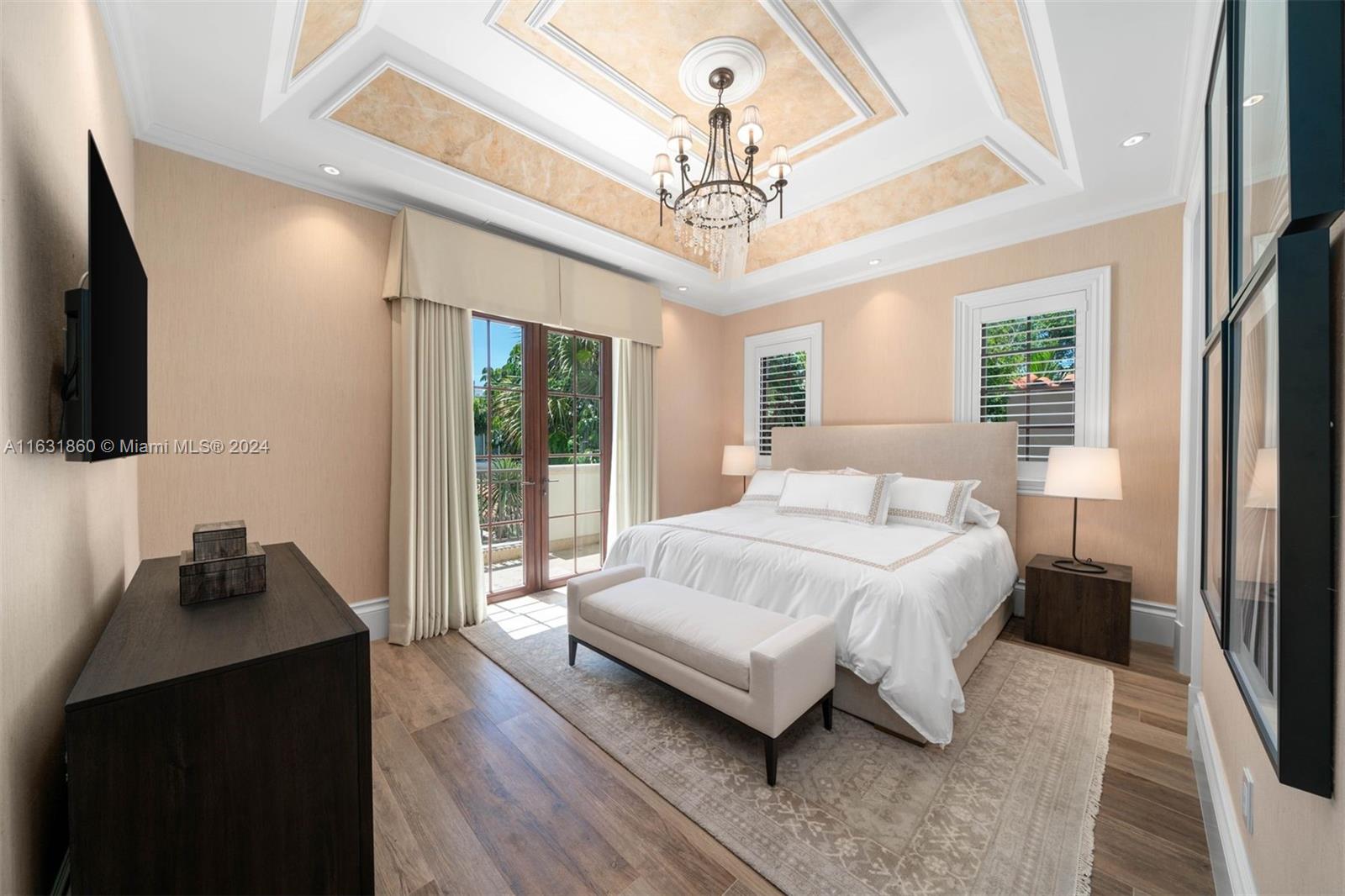 7825 Atlantic Way Miami Beach, FL 33141 - Photo 30 of 33 a spacious bedroom with a bed a flat screen tv and a large window