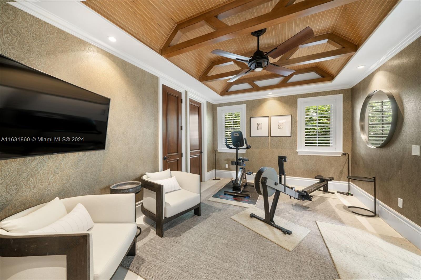 7825 Atlantic Way Miami Beach, FL 33141 - Photo 31 of 33 a living room with furniture a flat screen tv and a wall