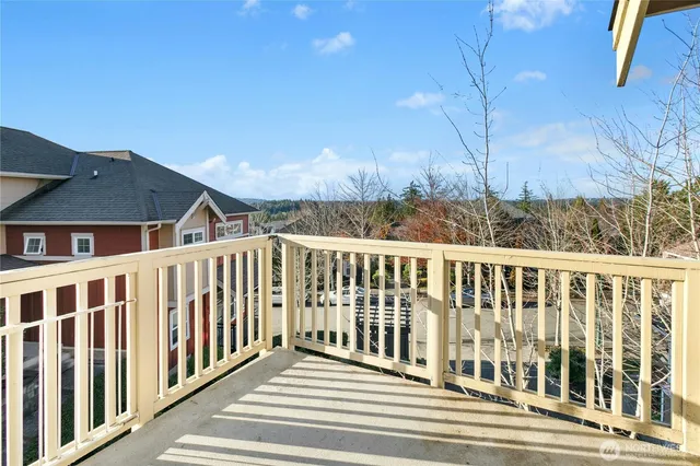a view of a brick house with a small yard