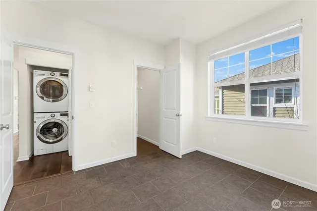 a view of a bedroom with washer and dryer